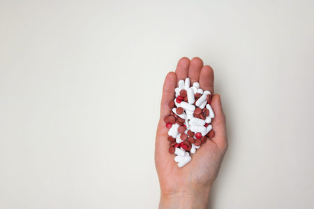 Minimalist Studio Shot Capturing Adult Hand Offering Various Medication Forms With Clinical Ambiance
