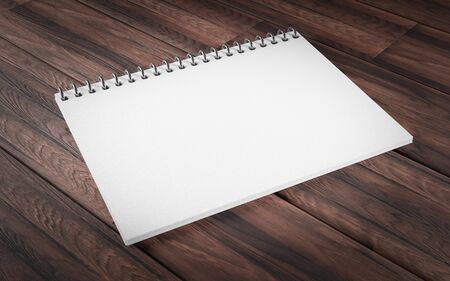 Blank ring bound scrap book on a rustic wooden background in horizontal orientation with copy space 3d render illustrationの写真素材