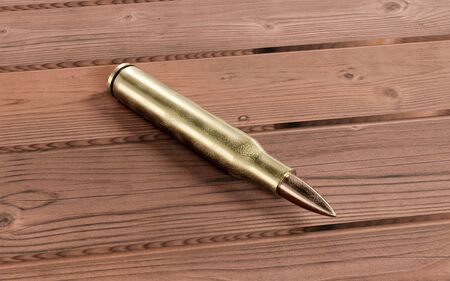 Golden bronze Rifle bullet on wooden table 3d render illustrationの写真素材