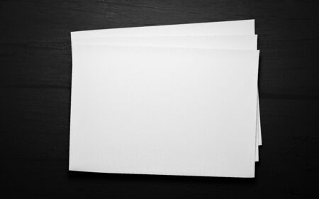 empty blank horicontal sheets isolated on dark wood background to replace your design 3d illustration renderの写真素材