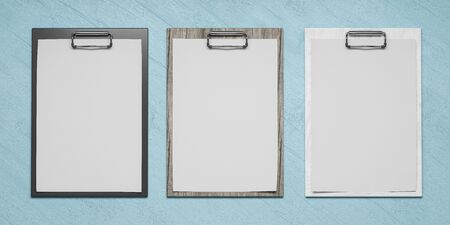 different coloured plastic and wooden clipboards with blank paper sheet isolated on cyan backgroundの写真素材