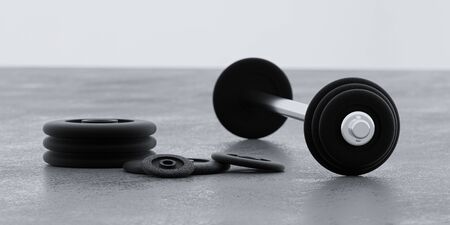 long metal dumbbells and black weights on gym floor and white background 3d illustration renderの写真素材
