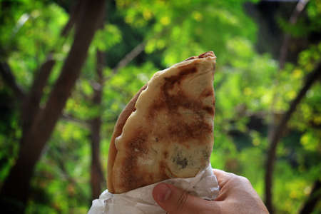 A man holding a mankousheh, traditional Lebanese breakfast.の写真素材