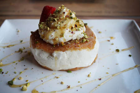 A Lebanese dessert made of ashta and vanilla ice cream with pistachios and drizzled with honey.