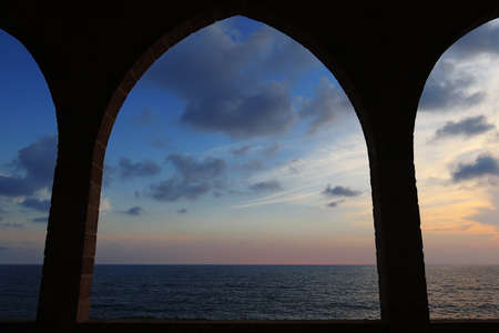 View of the Mediterranean sea through arches in Batroun, Lebanon.