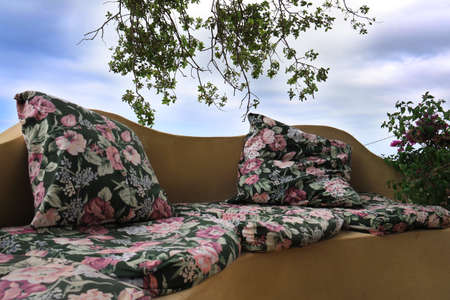 A seating area made comfortable with cushions in the garden.の写真素材