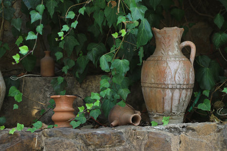 Lebanese terracota jars in the garden among green leaves.の写真素材