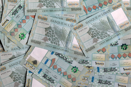 Stacks of Lebanese pounds, 100,000 denomination, symbolizing the downfall of the Lebanese currency.