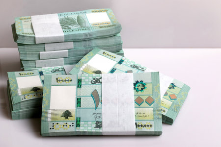 Stacks of Lebanese pounds, 100,000 denomination, symbolizing the downfall of the Lebanese currency.