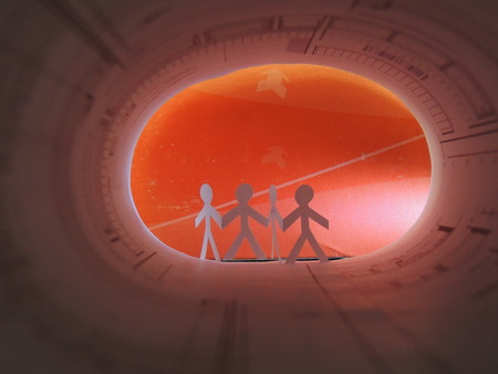 cutted paper of four people in a roll of a project planの写真素材