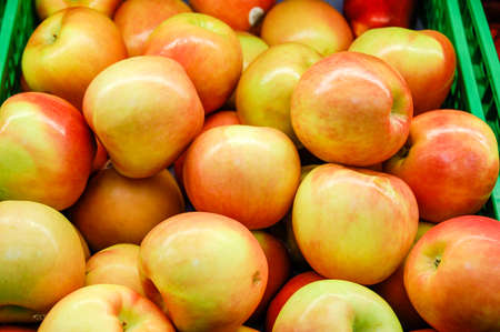 Close up of a bunch of yellow and red applesの写真素材