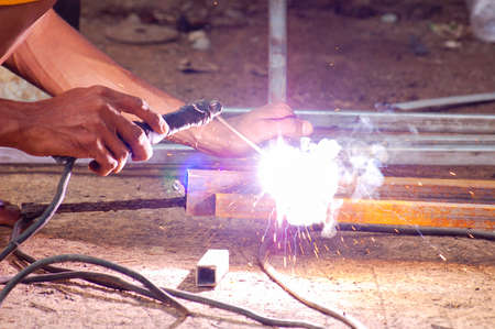 Close up of hands and arc welder