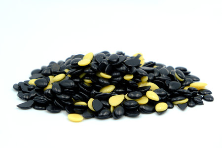 Depilatory Pearl Hard Wax Beans, black and white color. Waxing granules isolated on white backgroundの写真素材