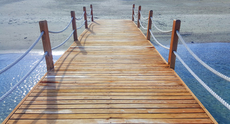 Wooden pier on tropical beachの写真素材