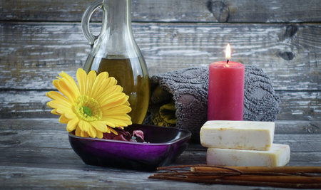 Spa still life with candle, soap and flower on wooden backgroundの写真素材
