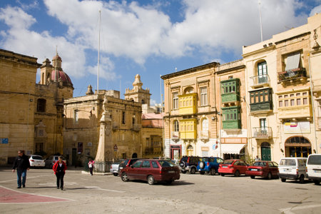 Birgu, Malta, April 9th, 2012: People walking in Victory Square in the city La Vittoriosa, also known as Birgu, in Maltaのeditorial素材