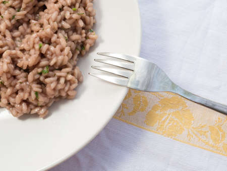An Italian risotto prepared with radicchio, a kind of chicory, and a touch of parsleyの写真素材