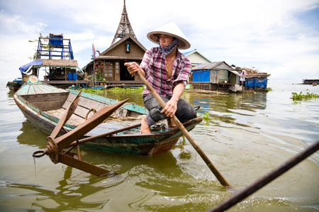 Kompong luong, Cambodia - 2010, August 13 : A Cambodian woman in a boat in the floating village of Kompong Luong on the Tonle Sap lake in Cambodiaのeditorial素材