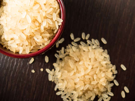 Uncooked italian risotto rice in a small bowlの写真素材