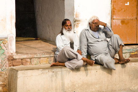 Jodhpur, India - 2015, January 1 : Two indian men sitting in the courtyard of a Hinduist temple in the town of Jodhpur, Rajasthan, Indiaのeditorial素材