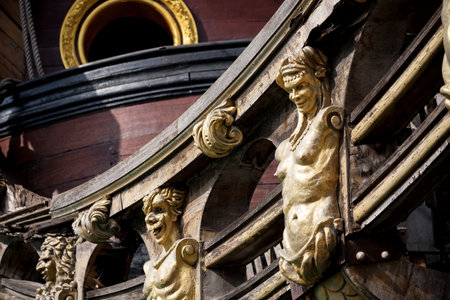 Genoa, Italy - 2016, March 19: A detail of the decorations on the side of the replica of a Spanish galleon in the harbor of Genoa in northern Italyのeditorial素材
