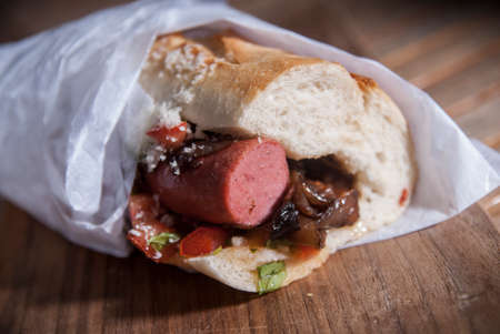 Frankfurter Hot Dog with Caramelized Onion, Pico De Gallo and Grated Parmesan Cheeseの写真素材