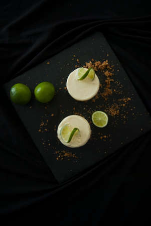 Lemon Lime Parfait with Crumbles on a Black Backgroundの写真素材