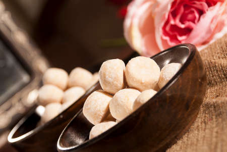 Cookies in a Wooden Bowl with Pink Rose Flowersの写真素材
