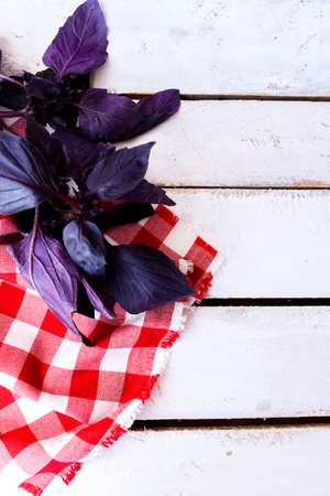 Basil on a White Background with a Gingham Kitchen Towelの写真素材