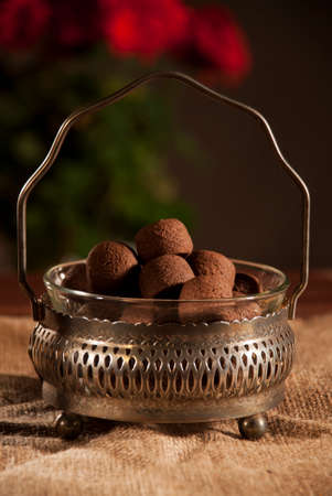 Chocolate Cookies in a Vintage Bowl on a Sack with Red and Pink Flowers