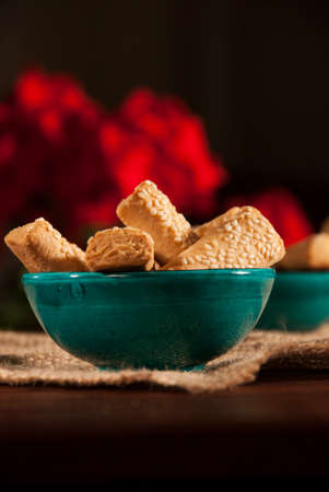 Rusk in a Turquoise Bowl on a Sack with Red Flowersの写真素材