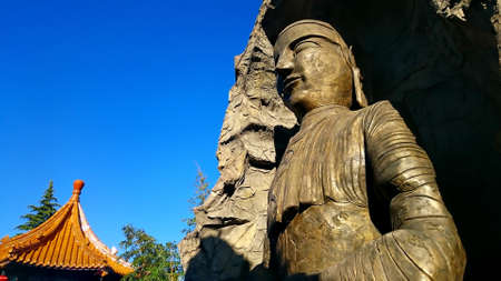 Buddah statue and chinese roofの写真素材