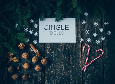 Merry Christmas and Jingle Bells on wood Backgroundの写真素材