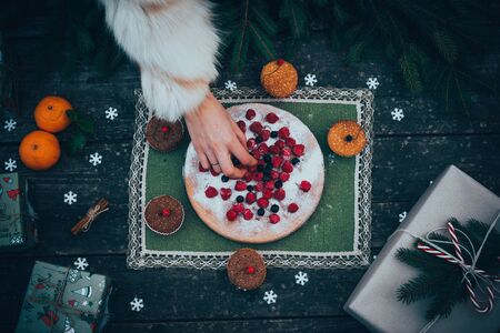 homemade christmas pie holiday dessert in new year tree decorations frame on vintage wooden table backgroundの写真素材