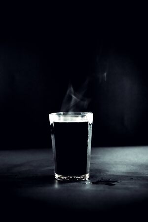 Cup with hot coffee on a dark backgroundの写真素材