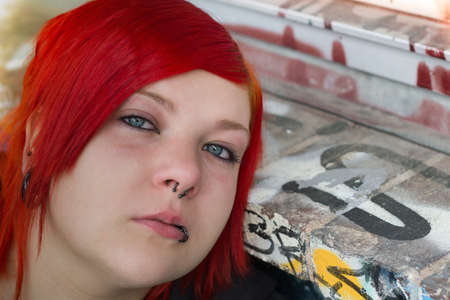 Beautiful red-heared girl,graffito backgroundの写真素材
