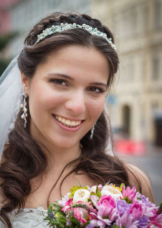 Happy smiling bride with bouqet outdoorsの写真素材