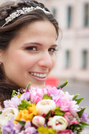 Happy smiling bride with bouqet outdoorsの写真素材