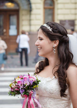 Bride with bouquet of flowers before the marriage registryの写真素材