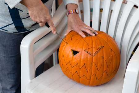Close up of making of jack-o-lantern from a big pumpkinの写真素材