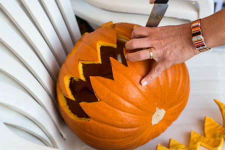 Close up of making of jack-o-lantern from a big pumpkinの写真素材