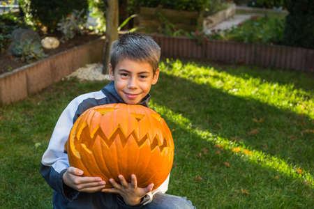 Boy, child with a big pumpkin, jack-o-lanternの写真素材