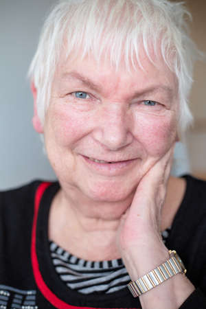 Portrait of happy older senior female with short white hairの写真素材