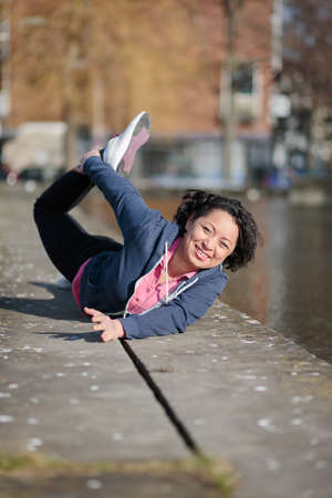 Healthy latina woman exercising in the city while joggingの写真素材