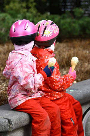 Children cyclists eating ice creamの写真素材