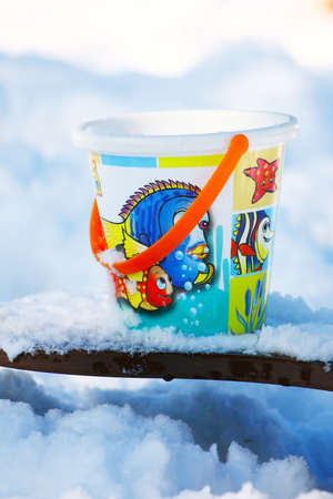 Toy bucket on the snowの写真素材