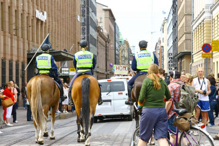 HELSINKI, FINLAND - JUNE 30: Mounted police protect people taking part in the annual Helsinki Pride gay parade in Helsinki, Finland on June 30, 2012. のeditorial素材