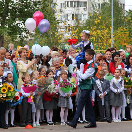 Moscow, Russia - September 1, 2015: School line is in schoolyard with pupils and teachers. Children go back to school. The Knowledge Day in Russia, first day of school.のeditorial素材