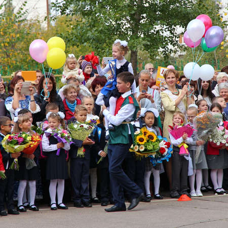 Moscow, Russia - September 1, 2015: School line is in schoolyard with pupils and teachers. Children go back to school. The Knowledge Day in Russia, first day of school.のeditorial素材