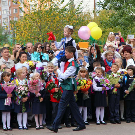 Moscow, Russia - September 1, 2015: School line is in schoolyard with pupils and teachers. Children go back to school. The Knowledge Day in Russia, first day of school.のeditorial素材